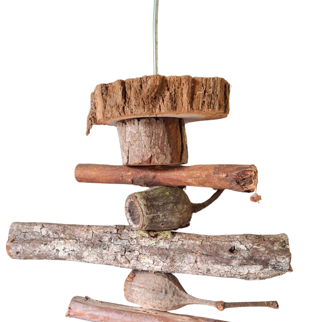 Top view of natural bird toy with chunky wood slices and gumnuts